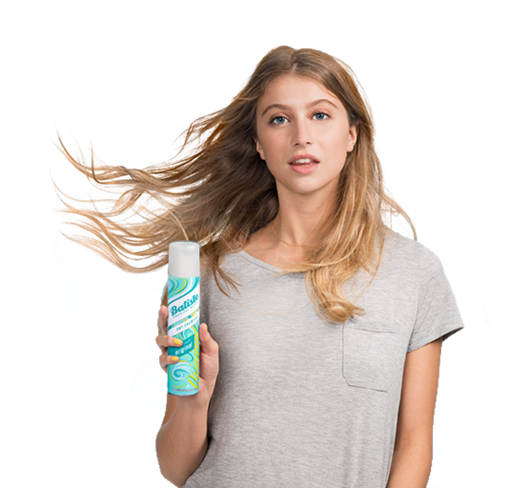 Woman showing how to use dry shampoo.